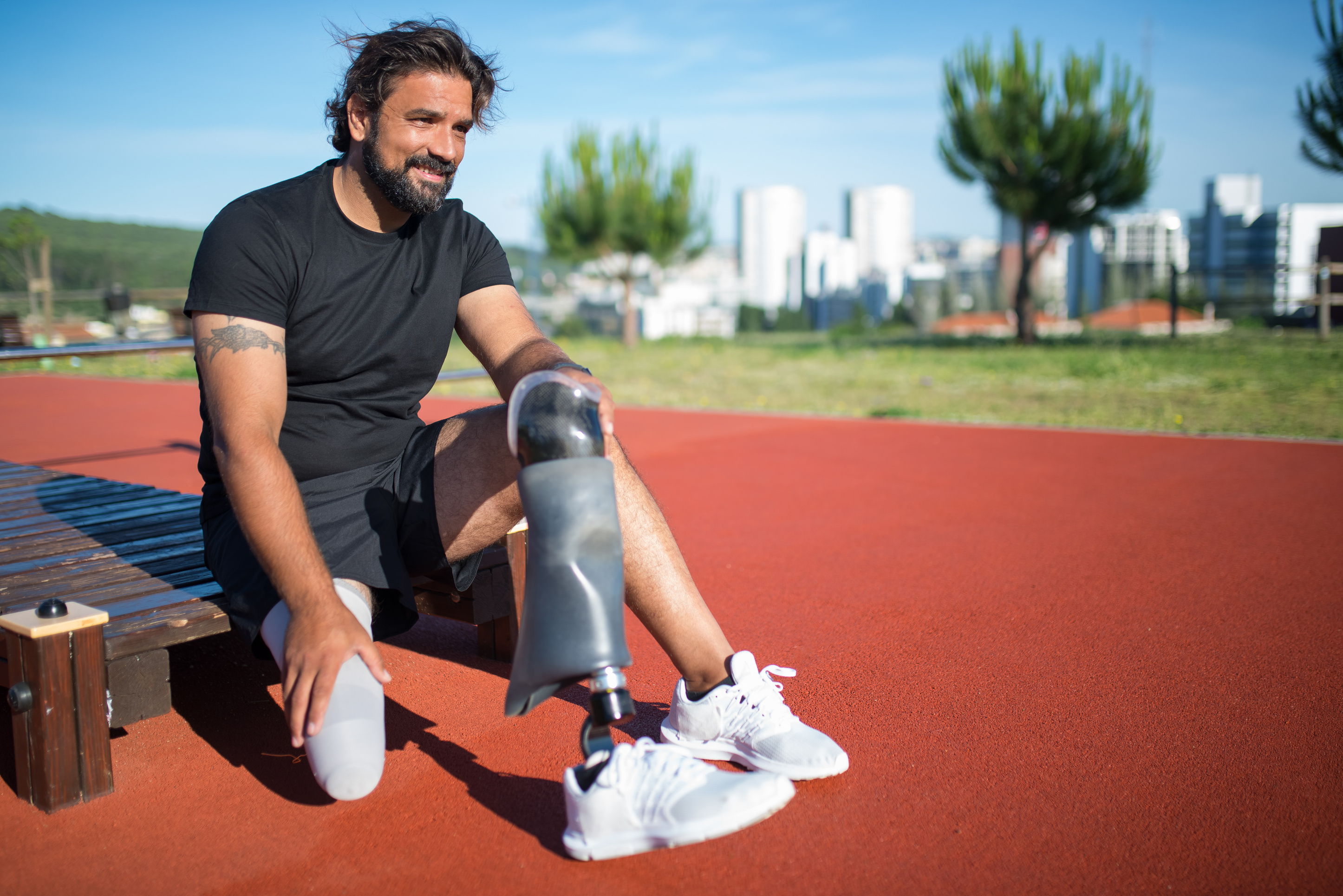 Man in Black Shirt Holding a Prosthetic Leg