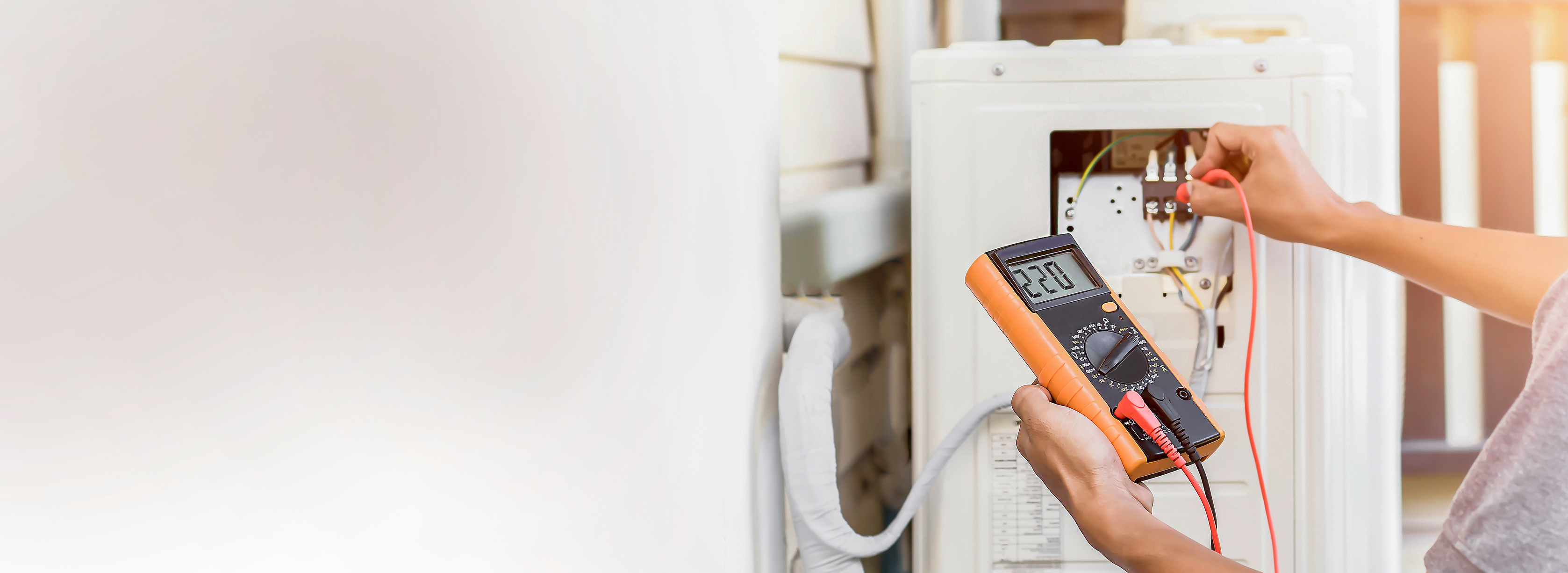 Air conditioning, HVAC service technician using gauges to check refrigerant and add refrigerant.